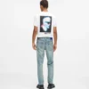 Taps toelopende jeans met verfspatten